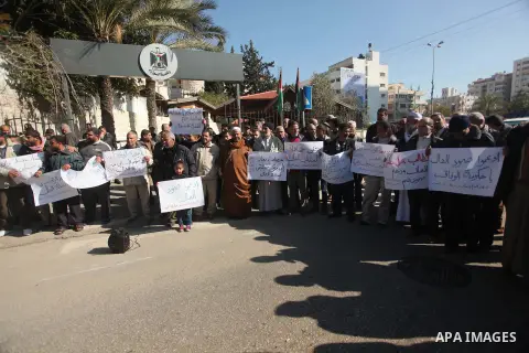 Palestinians take part in a protest organized by employees of former Palestinian government demanding their salaries to be paid, in front of the headquarters of the Council of Ministers in Gaza city on January 20, 2015....