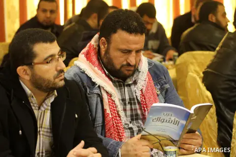 Palestinians attend the ceremony of a newly published book " The Path of Thorns," written by Palestinian prisoner Saleem Hejja, in Gaza city on January 20, 2015. Photo by Mohammed Asad