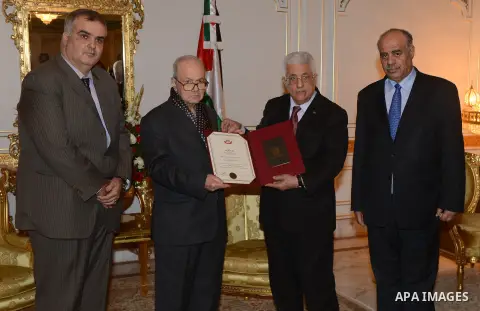 Palestinian President Mahmoud Abbas honors Farouk Kaddoumi, the Member of the Executive Committee of the Palestine Liberation Organization, in Tunis, January 22, 2015. Photo by Thaer Ganaim