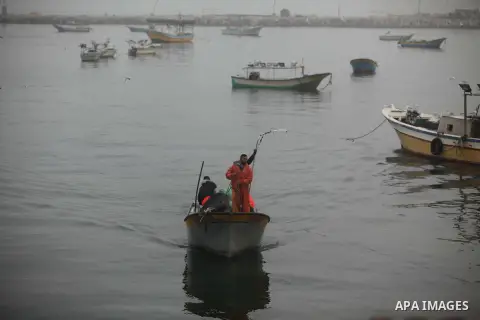 Palestinian fishermen ride their boats into the water in the port of Gaza City on January 25, 2015. Israel's navy opened fire at fishing boats off the coast of the Gaza Strip on January 21, 2015 wounding two Palestinian...