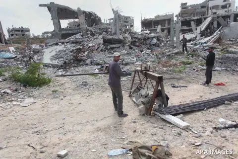 Palestinian workers extract iron from the rubbles of houses that witnesses said was destroyed by Israeli shelling during the most recent conflict between Israel and Hamas, in Shijaiyah neighborhood, east Gaza city on Jan...