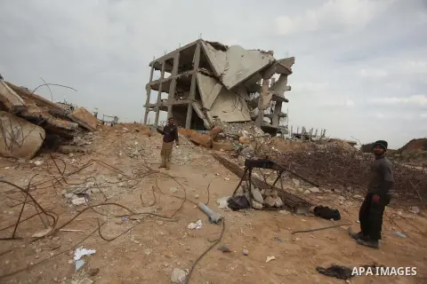 Palestinian workers extract iron from the rubbles of houses that witnesses said was destroyed by Israeli shelling during the most recent conflict between Israel and Hamas, in Shijaiyah neighborhood, east Gaza city on Jan...