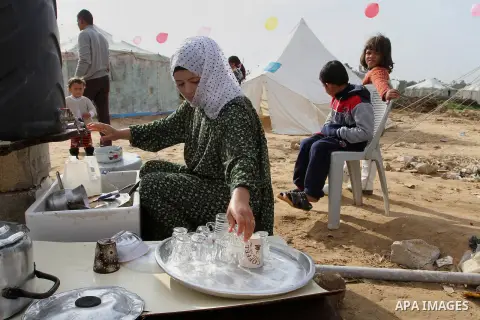 A Palestinian woman, whose house was destroyed by what witnesses said was Israel shelling during a 50-day conflict last summer, works outside her tent east of Khan Younis in the southern Gaza Strip January 27, 2015. The...