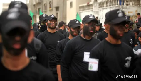 Palestinian youth, who are participating in a Hamas military-style camp, march during a protest rally in support of the Prophet Mohammed in Gaza City on January 27, 2015. Photo by Ashraf Amra
