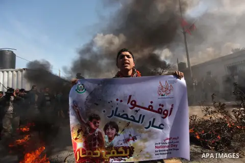 Palestinian protesters attack the headquarters of the United Nations in Gaza city on January 28, 2015 after the UN announced a lack of funds to rebuild the Palestinian territory. Around 200 people demonstrated outside he...