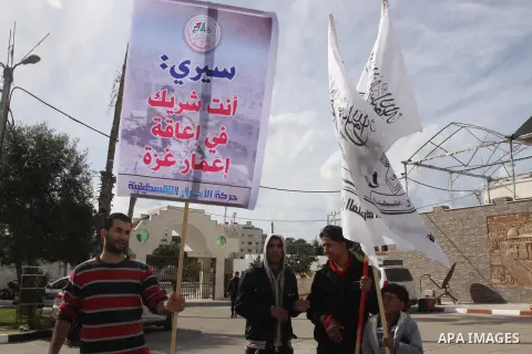 Palestinian supporters of al-Ahrar movement, take part a protest against the decision by the main U.N. aid agency to suspend payments to tens of thousands of Palestinians for repairs to their homes damaged in last summer...
