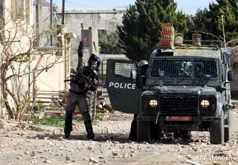 An Israeli soldier throws a tear gas canister towards Palestinian protesters during clashes following a demonstration against the expropriation of Palestinian land by Israel in the village of Kfar Qaddum, near Nablus in...
