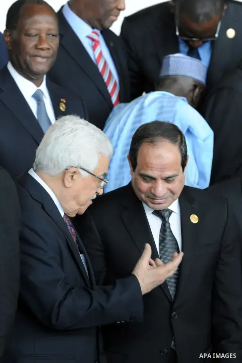 Palestinian President Mahmoud Abbas talks with Egypt's President Abdel-Fattah al-Sisi during the opening ceremony of the 24th Ordinary session of the Assembly of Heads of State and Government of the African Union (AU) at...
