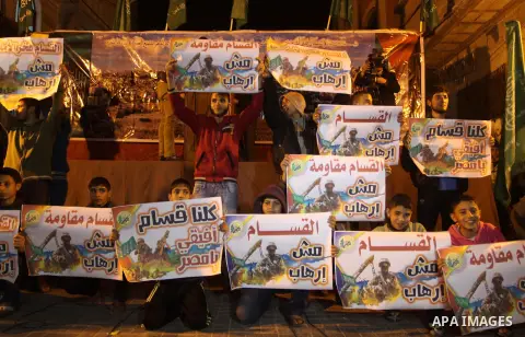 Palestinian supporters of Hamas movement hold banners during a rally against the Egyptian court decision to list Ezz Eddin al-Qassam brigades as a "terrorist group", in Jabalia in the northern Gaza Strip, February 2, 201...