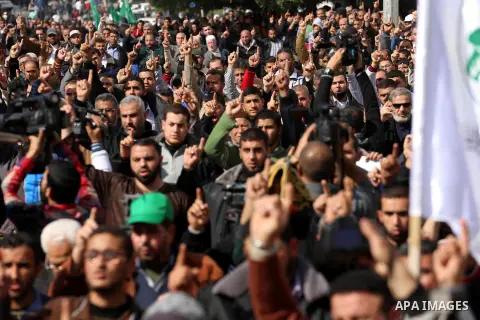 Palestinian Hamas supporters attend Friday prayers outside the Egyptian embassy in a protest to condemn the decision of an Egyptian court to ban the armed wing of Palestinian Islamist movement, in Gaza city on February 6...