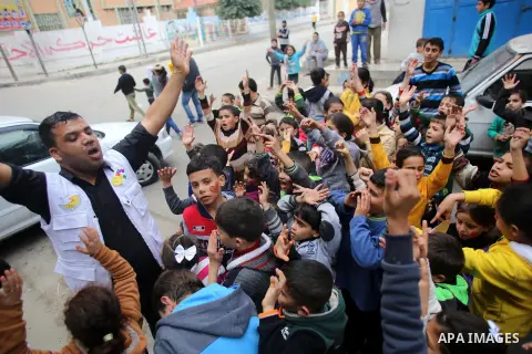 A volunteer of the Friday of Joy Initiative, plays with children in the street in al-Shati refugee camp, in Gaza city, February 6, 2015. Ten Palestinian volunteers organise street games, painting and drama, every Friday...