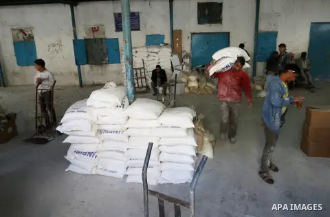 Palestinians receive their monthly food aid at a United Nations distribution center (UNRWA) in the Rafah refugee camp, in southern Gaza Strip on February 8, 2015. UN Secretary General Ban Ki-moon called on Friday for int...