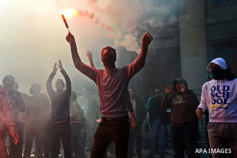 An Egyptian student who supports ousted President Mohamed Morsi and the Muslim Brotherhood lights up a flare as they protest in Cairo University on February 8, 2015. Due to the escalation of students protest in the campu...