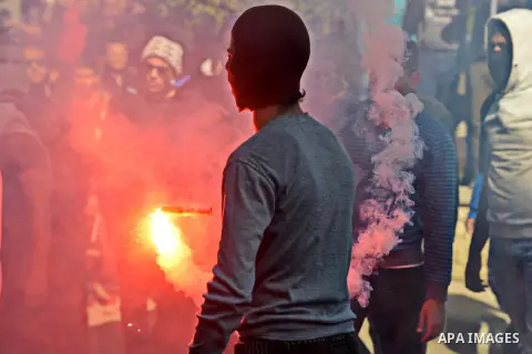 An Egyptian student who supports ousted President Mohamed Morsi and the Muslim Brotherhood lights up a flare as they protest in Cairo University on February 8, 2015. Due to the escalation of students protest in the campu...