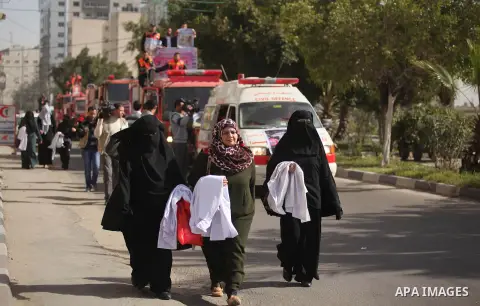 Palestinian employees of Civil defense march on a streets during a protest to demanding their salaries, in Gaza city, on February 10, 2015. Photo by Ashraf Amra