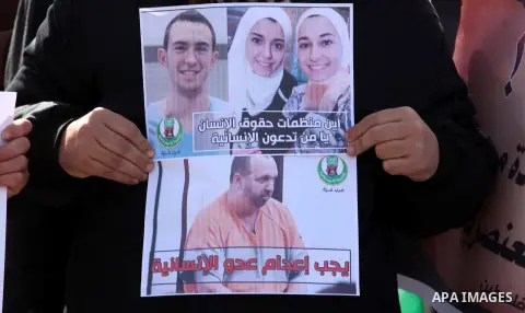 Palestinians take part in a protest against the murders of three Muslim students in Carolina, outside the UN headquarters in Gaza city on February 12, 2015. Craig Stephen Hicks, 46, has been charged with three counts of...