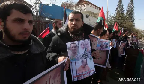 Palestinians take part in a protest against the murders of three Muslim students in Carolina, outside the UN headquarters in Gaza city on February 12, 2015. Craig Stephen Hicks, 46, has been charged with three counts of...