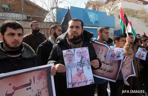 Palestinians take part in a protest against the murders of three Muslim students in Carolina, outside the UN headquarters in Gaza city on February 12, 2015. Craig Stephen Hicks, 46, has been charged with three counts of...