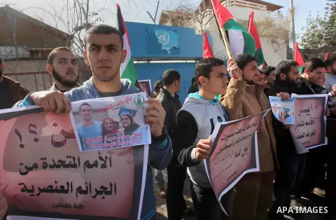 Palestinians take part in a protest against the murders of three Muslim students in Carolina, outside the UN headquarters in Gaza city on February 12, 2015. Craig Stephen Hicks, 46, has been charged with three counts of...