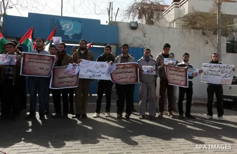 Palestinians take part in a protest against the murders of three Muslim students in Carolina, outside the UN headquarters in Gaza city on February 12, 2015. Craig Stephen Hicks, 46, has been charged with three counts of...