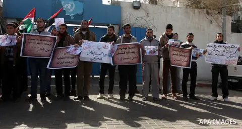 Palestinians take part in a protest against the murders of three Muslim students in Carolina, outside the UN headquarters in Gaza city on February 12, 2015. Craig Stephen Hicks, 46, has been charged with three counts of...