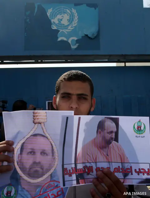 Palestinians take part in a protest against the murders of three Muslim students in Carolina, outside the UN headquarters in Gaza city on February 12, 2015. Craig Stephen Hicks, 46, has been charged with three counts of...
