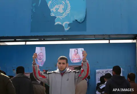 Palestinians take part in a protest against the murders of three Muslim students in Carolina, outside the UN headquarters in Gaza city on February 12, 2015. Craig Stephen Hicks, 46, has been charged with three counts of...