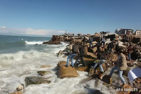 Palestinians throw flowers into the sea, in remembrance of the Chapel Hill shooting victims, in Gaza City, February 14, 2015. Three young Muslims were gunned down in Chapel Hill, North Carolina, this week. Newlywed Deah...