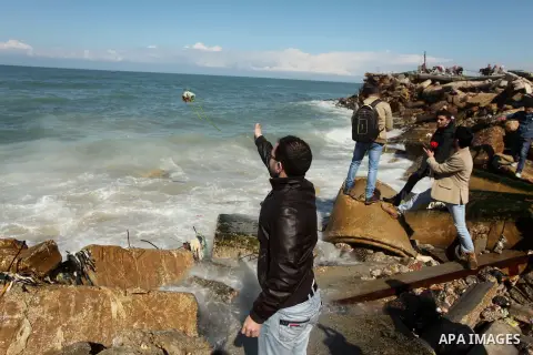 Palestinians throw flowers into the sea, in remembrance of the Chapel Hill shooting victims, in Gaza City, February 14, 2015. Three young Muslims were gunned down in Chapel Hill, North Carolina, this week. Newlywed Deah...