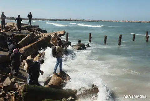 Palestinians throw flowers into the sea, in remembrance of the Chapel Hill shooting victims, in Gaza City, February 14, 2015. Three young Muslims were gunned down in Chapel Hill, North Carolina, this week. Newlywed Deah...