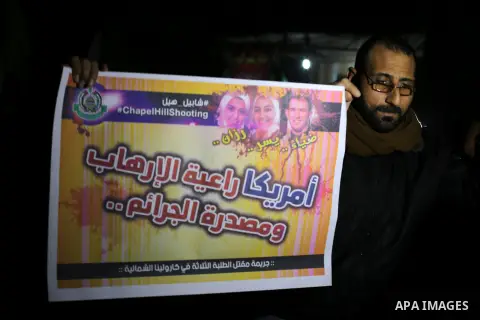 Palestinians take part during a protest to condemn Chapel Hill shooting victims, the three young Muslims who were gunned down in North Carolina this week, in Jabalia in Gaza City, February 14, 2015. Newlywed Deah Shaddy...