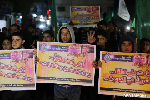 Palestinians take part during a protest to condemn Chapel Hill shooting victims, the three young Muslims who were gunned down in North Carolina this week, in Jabalia in Gaza City, February 14, 2015. Newlywed Deah Shaddy...