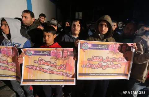 Palestinians take part during a protest to condemn Chapel Hill shooting victims, the three young Muslims who were gunned down in North Carolina this week, in Jabalia in Gaza City, February 14, 2015. Newlywed Deah Shaddy...