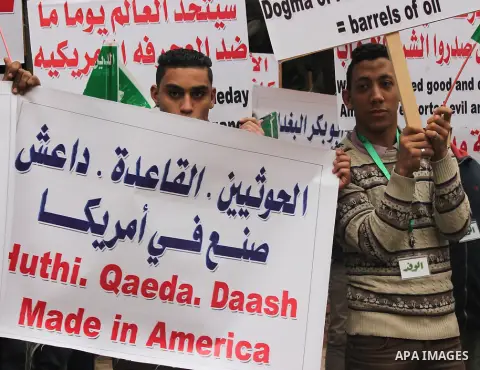 Egyptian supporters of the Wafd Party take part during a protest to condemn Chapel Hill shooting victims, the three young Muslims who were gunned down in North Carolina this week, in front of American Embassy, in Cairo F...