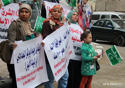 Egyptian supporters of the Wafd Party take part during a protest to condemn Chapel Hill shooting victims, the three young Muslims who were gunned down in North Carolina this week, in front of American Embassy, in Cairo F...