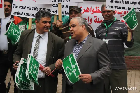 Egyptian supporters of the Wafd Party take part during a protest to condemn Chapel Hill shooting victims, the three young Muslims who were gunned down in North Carolina this week, in front of American Embassy, in Cairo F...