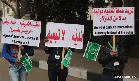 Egyptian supporters of the Wafd Party take part during a protest to condemn Chapel Hill shooting victims, the three young Muslims who were gunned down in North Carolina this week, in front of American Embassy, in Cairo F...