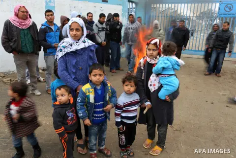 Palestinians take part in a protest calling for reconstruction of houses that witnesses said were destroyed by Israeli shelling during a 50-day war last summer, outside a United Nations food distribution center in Rafah...