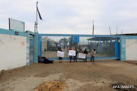Palestinians take part in a protest calling for reconstruction of houses that witnesses said were destroyed by Israeli shelling during a 50-day war last summer, outside a United Nations food distribution center in Rafah...