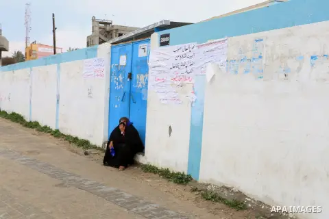 A Palestinian woman sitting as she takes part with others in a protest calling for reconstruction of their houses that witnesses said were destroyed by Israeli shelling during a 50-day war last summer, outside a United N...