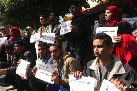 Palestinian youths take part during a protest against the murders of three Muslim students in Carolina, outside the Keir American foundation in Gaza city on February 16, 2015. Craig Stephen Hicks, 46, has been charged wi...