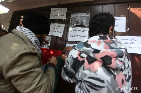 Palestinian youths take part during a protest against the murders of three Muslim students in Carolina, outside the Keir American foundation in Gaza city on February 16, 2015. Craig Stephen Hicks, 46, has been charged wi...