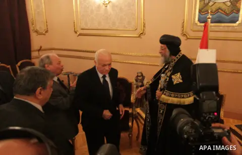 Arab League general secretary Nabil al-Arabi (L) offers his condolences to Egypt's Coptic Pope Tawadros II at Saint-Mark's Coptic Cathedral in Cairo's al-Abbassiya district on February 16, 2015, a day after the Islamic S...