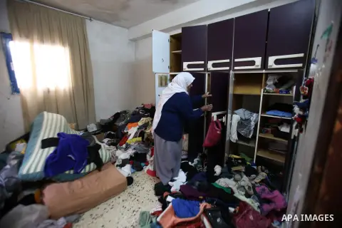 A Palestinian woman inspects the damages at her house after an Israeli military operation, in the West Bank village of Yatma south of Nablus Feb. 18, 2015. Israeli troops stormed three Palestinian villages in Nablus dist...