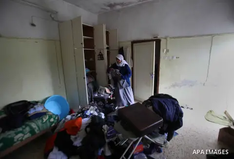 A Palestinian woman inspects the damages at her house after an Israeli military operation, in the West Bank village of Yatma south of Nablus Feb. 18, 2015. Israeli troops stormed three Palestinian villages in Nablus dist...