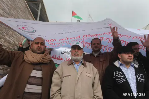Palestinian employees of former Palestinian government take part a protest demanding their salaries to be paid, in front of the Legislative Council in Gaza city on February 18, 2015. Some 40,000 civil servants employed b...