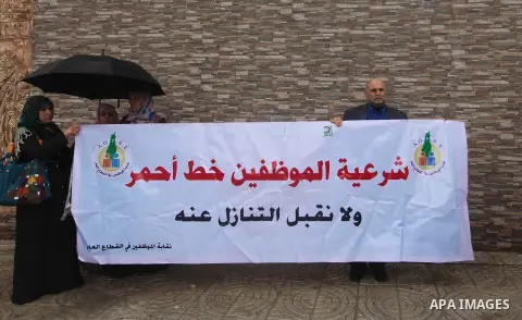 Palestinian employees of former Palestinian government take part a protest demanding their salaries to be paid, in front of the Legislative Council in Gaza city on February 18, 2015. Some 40,000 civil servants employed b...