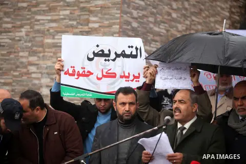 Former head of the union staff in Gaza, Mohammed Siam speaks during a protest demanding their salaries to be paid, in front of the Legislative Council in Gaza city on February 18, 2015. Some 40,000 civil servants employe...