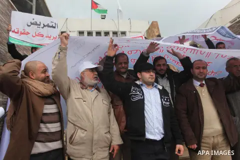 Palestinian employees of former Palestinian government take part a protest demanding their salaries to be paid, in front of the Legislative Council in Gaza city on February 18, 2015. Some 40,000 civil servants employed b...