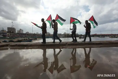 Supporters of Palestinian People's Party take part a protest demanding for reconstruction of the houses which were destroyed during the recent Israeli war, at the seaport near the coast of Gaza city, February 18, 2015. A...